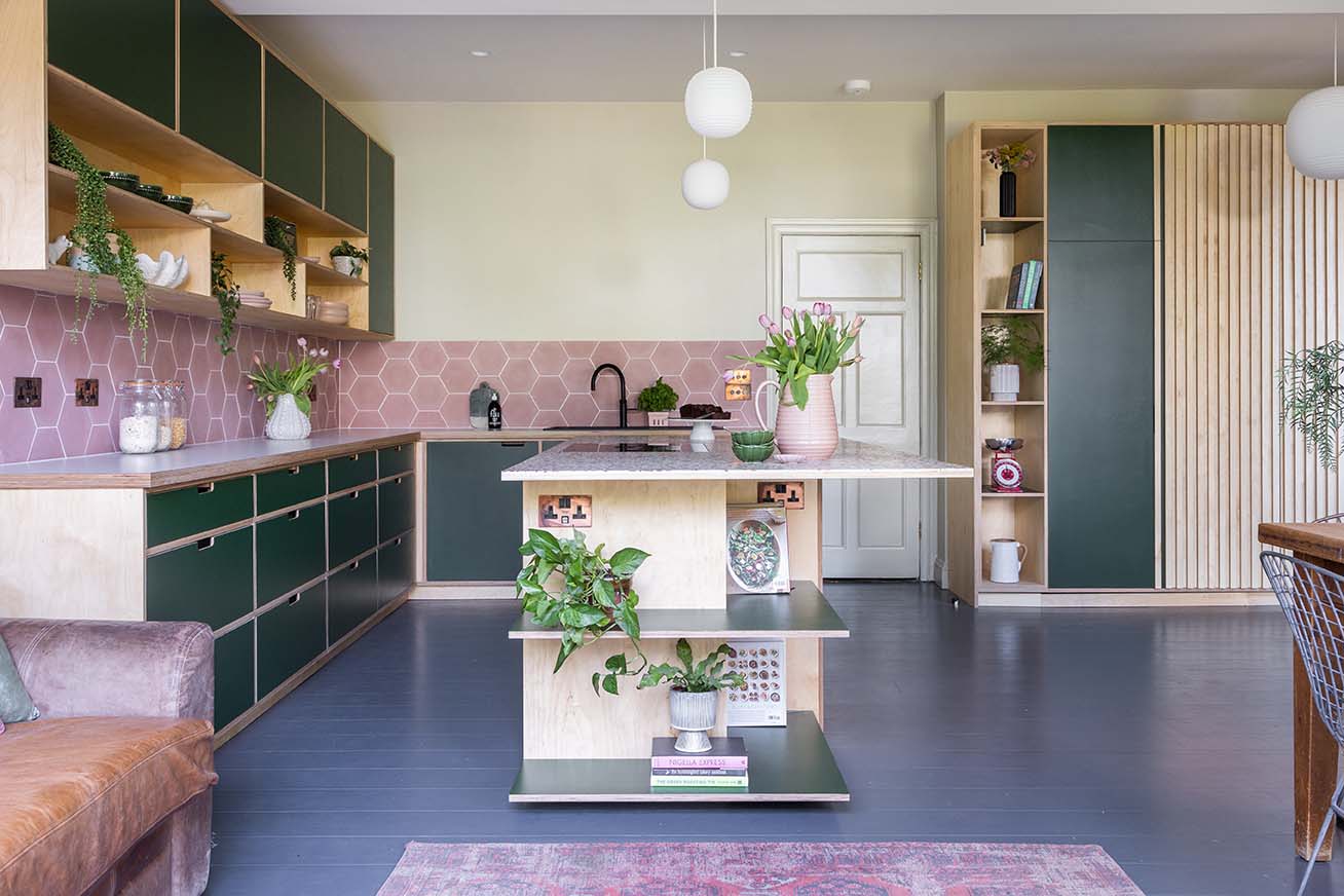 Green kitchen with pink hexagonal tile splashback
